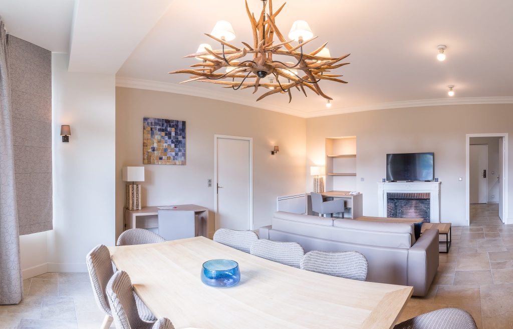 dining and living room area of the prestige suite in the villa odette deauville